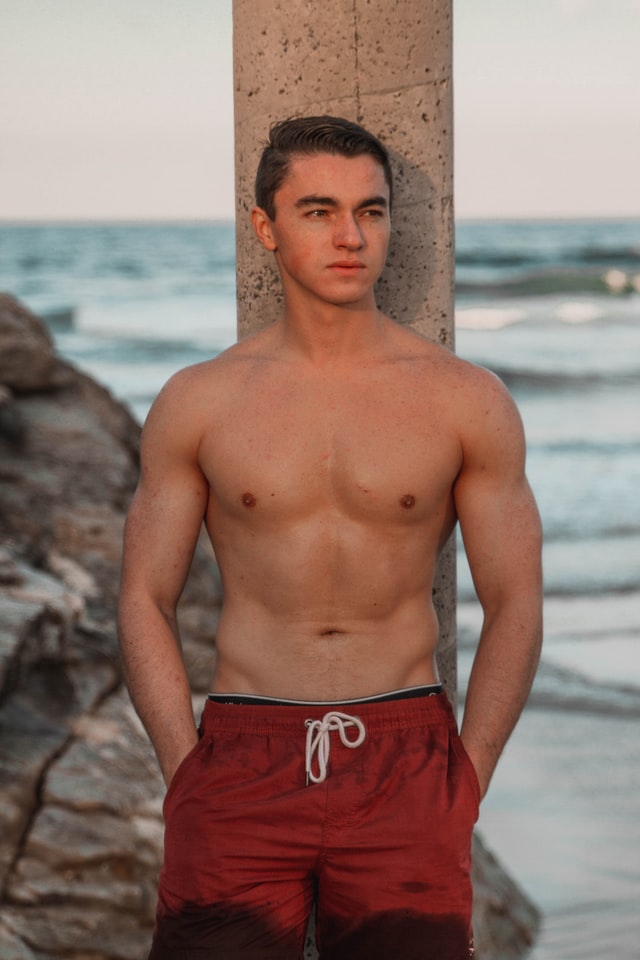 shirtless man at beach